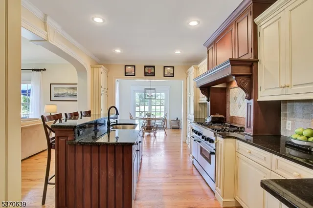 a kitchen with granite countertop a stove and cabinets
