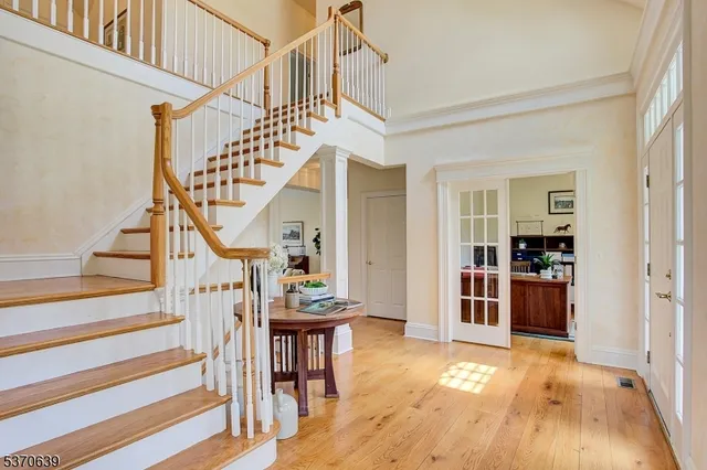 a view of entryway livingroom and hall with wooden floor