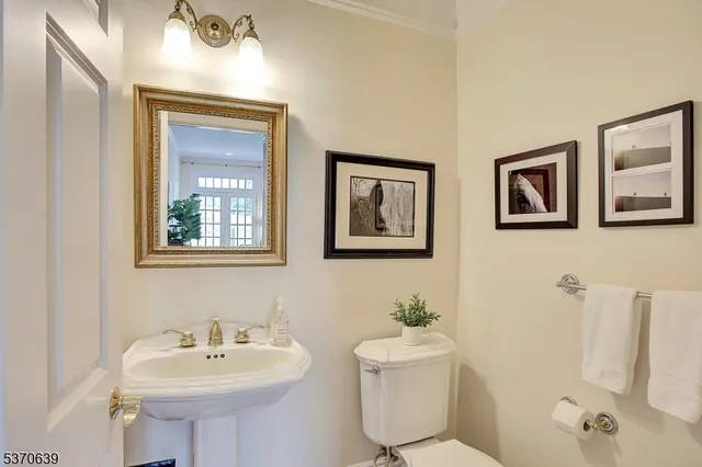a bathroom with a sink mirror and toilet