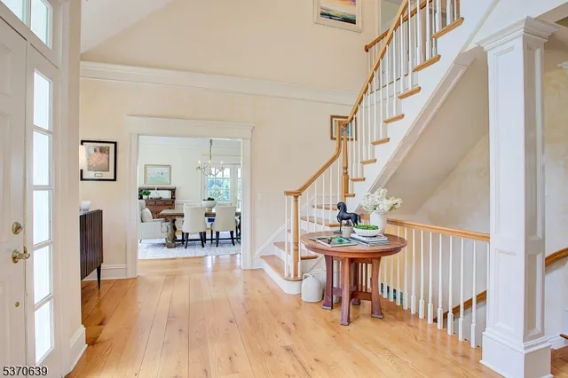 a view of a hallway with furniture and wooden floor