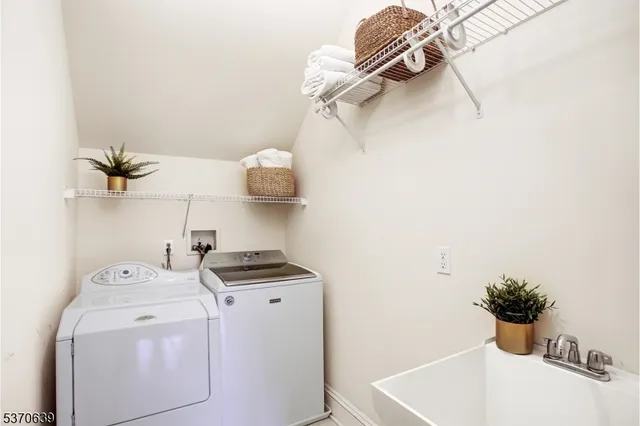 a view of storage and utility room with washer and dryer