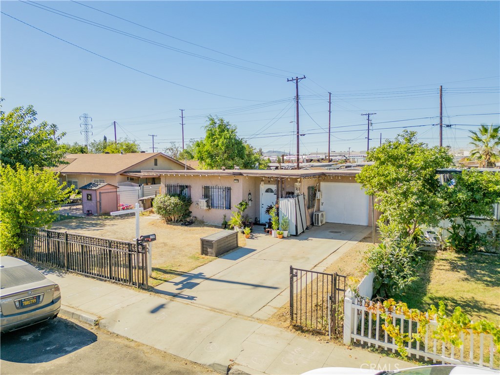 1709 Rialto Avenue Colton, CA 92324 - Photo 1 of 26 a view of a patio with table and chairs potted plants