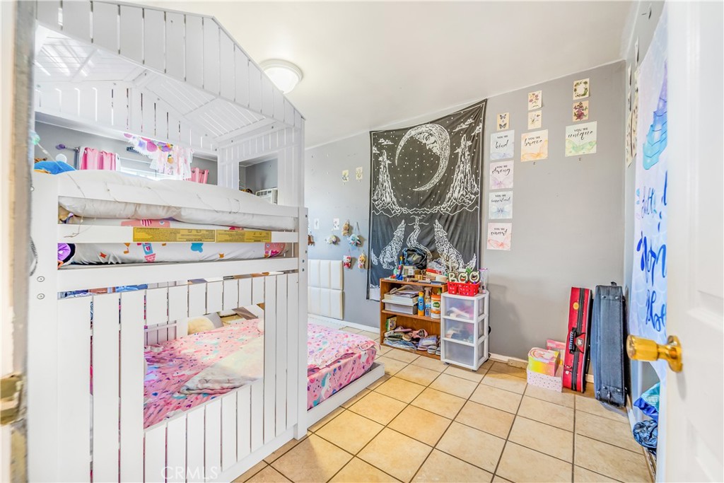 1709 Rialto Avenue Colton, CA 92324 - Photo 16 of 26 a bedroom with furniture and baby crib