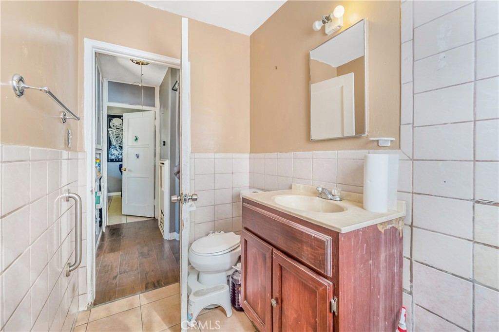 1709 Rialto Avenue Colton, CA 92324 - Photo 17 of 26 a bathroom with a sink toilet vanity and shower
