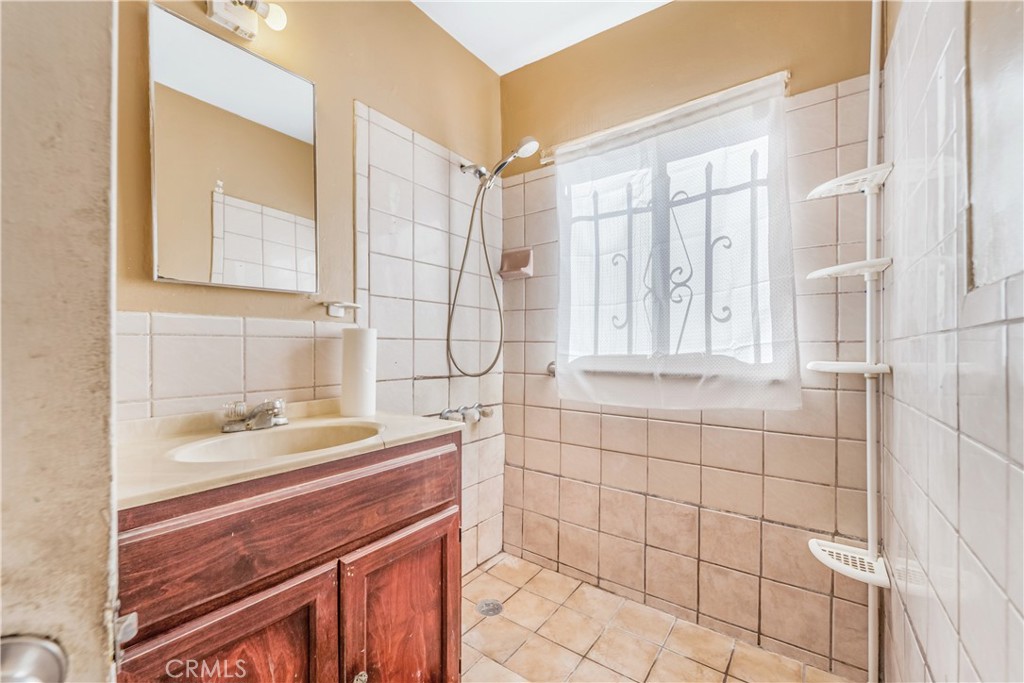 1709 Rialto Avenue Colton, CA 92324 - Photo 18 of 26 a bathroom with a sink and a mirror