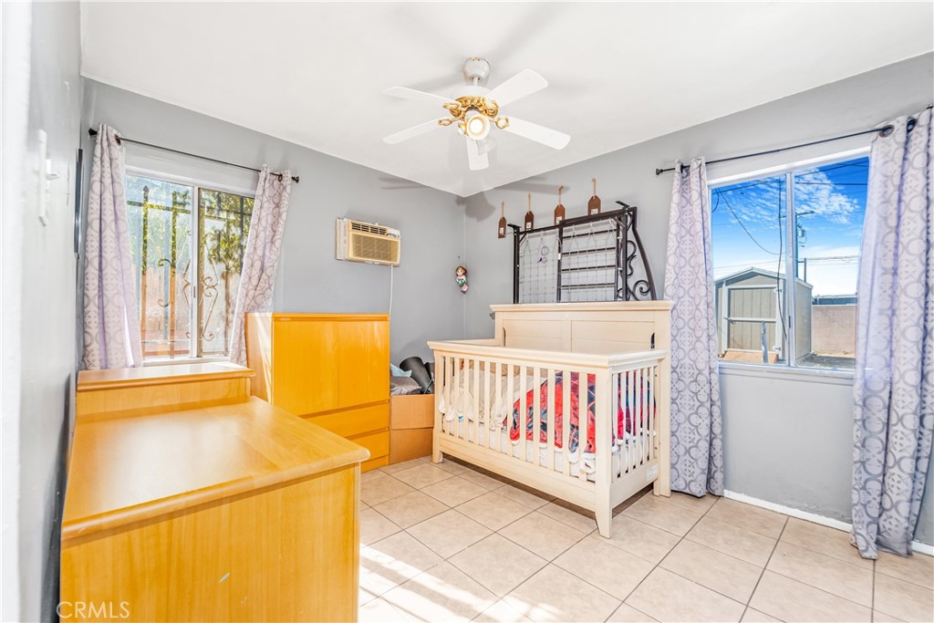 1709 Rialto Avenue Colton, CA 92324 - Photo 19 of 26 a white bed sitting in a room next to a window