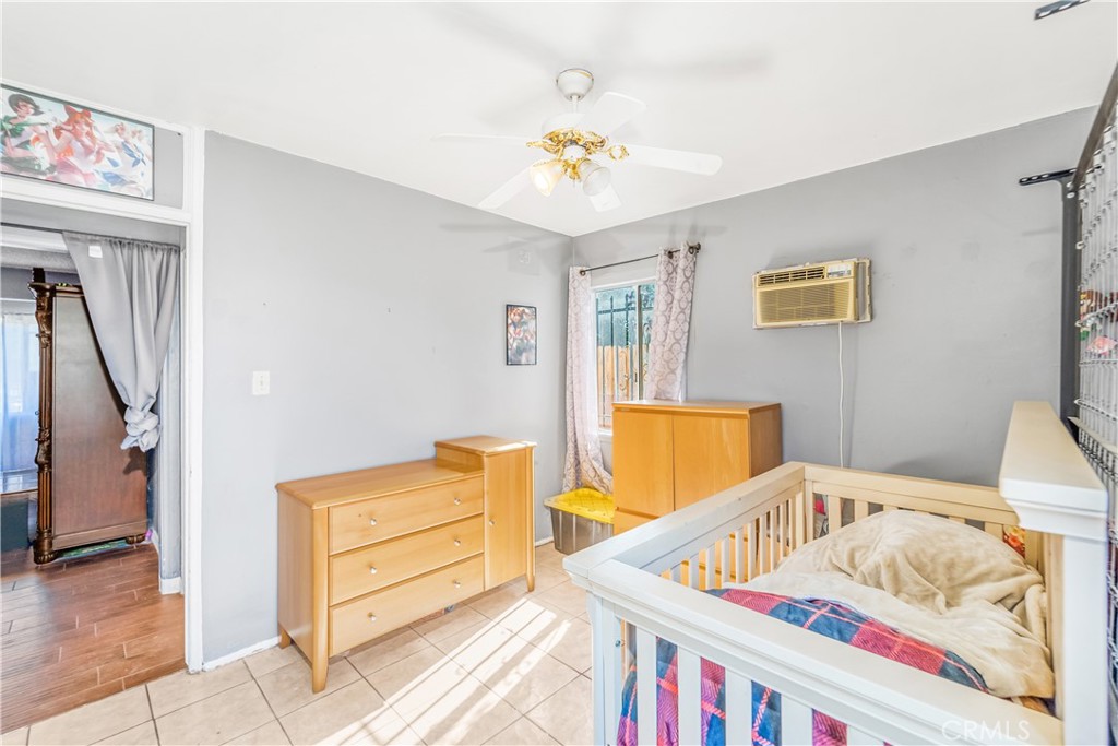 1709 Rialto Avenue Colton, CA 92324 - Photo 20 of 26 a bedroom with furniture and wooden floor