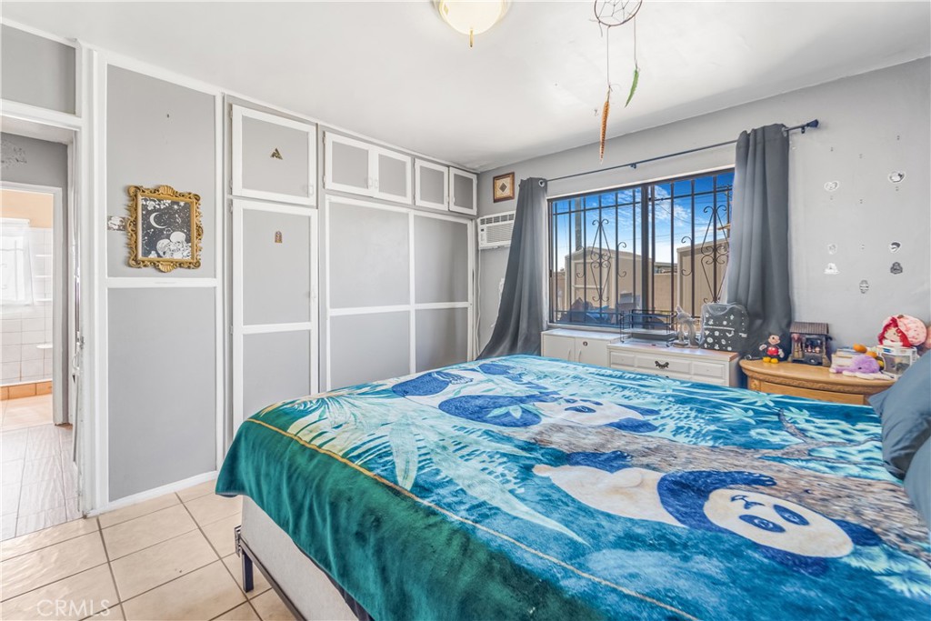 1709 Rialto Avenue Colton, CA 92324 - Photo 22 of 26 a bedroom with a bed and a dresser