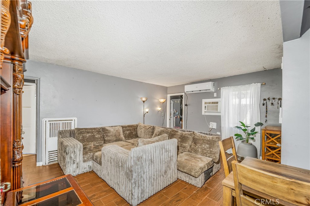 1709 Rialto Avenue Colton, CA 92324 - Photo 9 of 26 a living room with furniture and wooden floor