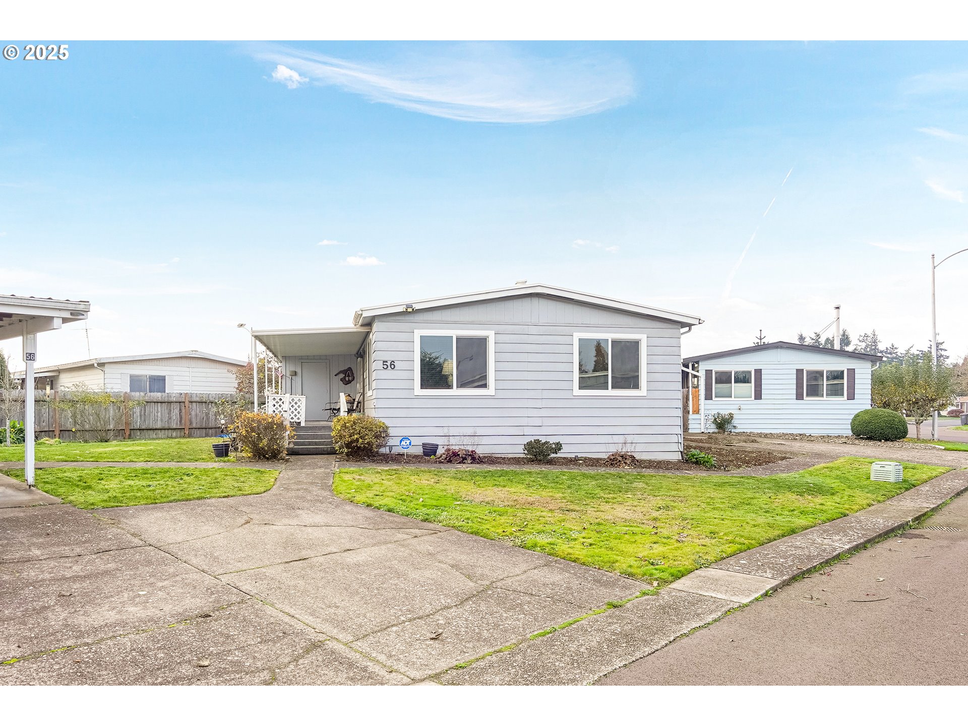 a view of a house with a patio and a yard