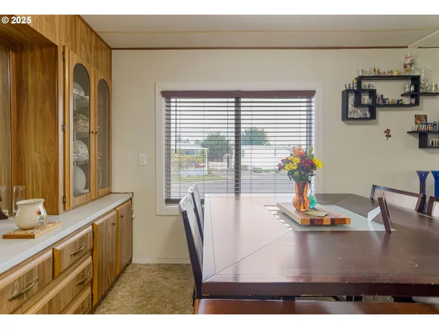 a dining table with chair and window