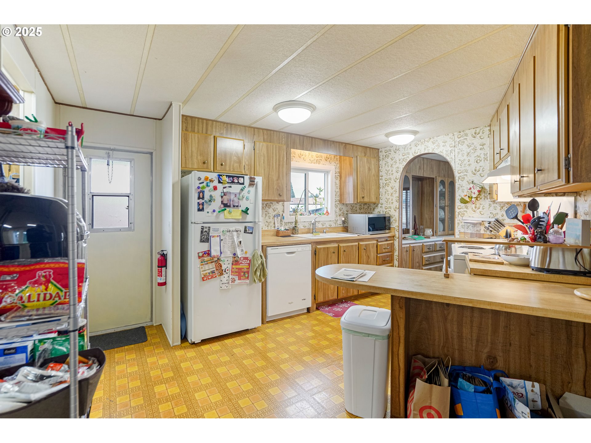 5422 Portland Road Northeast, Unit 56 Salem, OR 97305 - Photo 13 of 38 a kitchen with stainless steel appliances kitchen island granite countertop a refrigerator and a sink