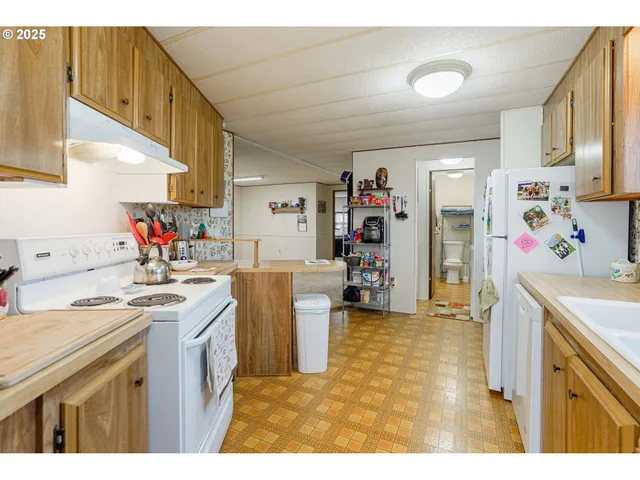 a kitchen with a sink stove and refrigerator