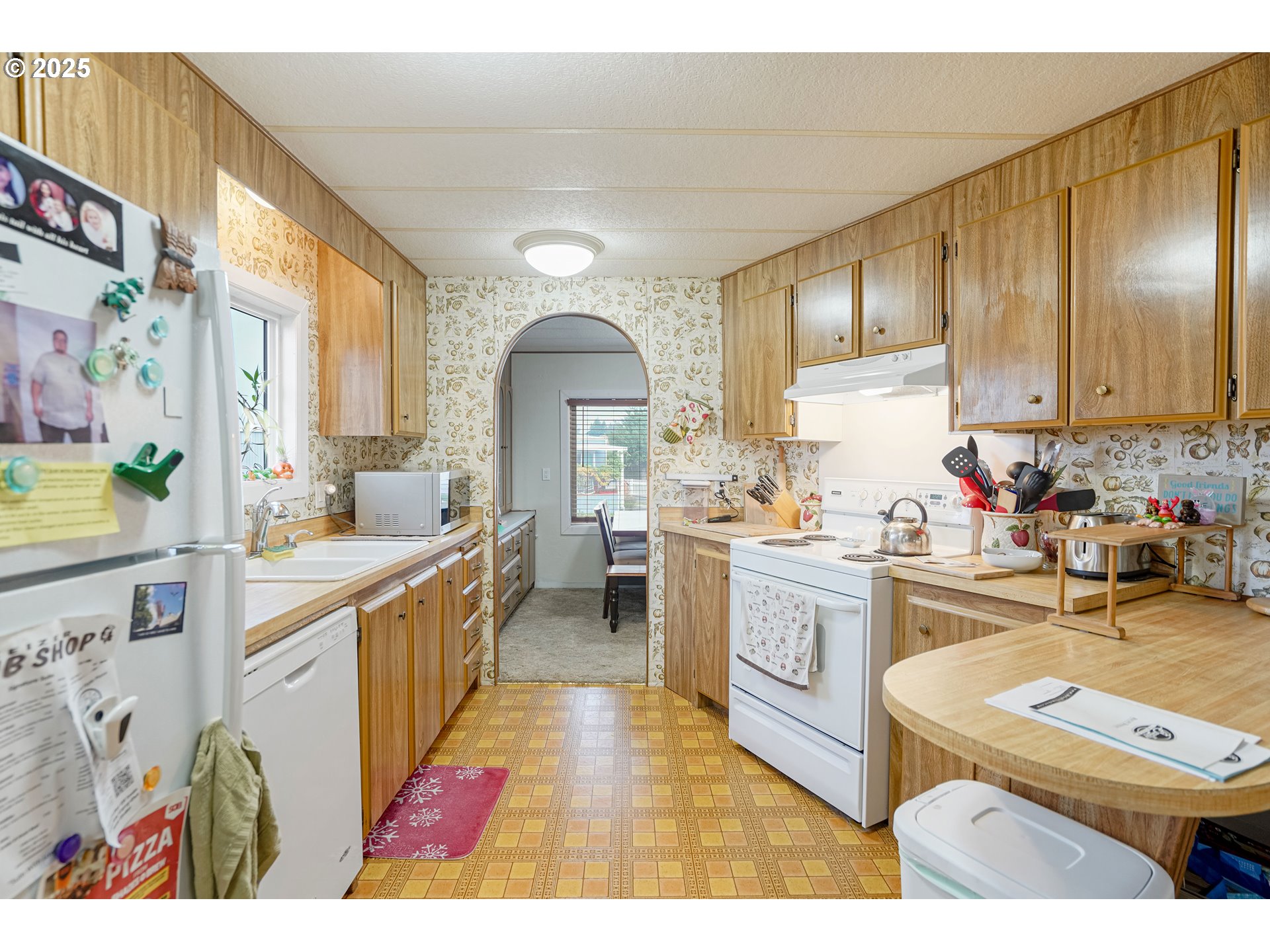 5422 Portland Road Northeast, Unit 56 Salem, OR 97305 - Photo 17 of 38 a large kitchen with stainless steel appliances granite countertop a stove a sink dishwasher and cabinets with wooden floor