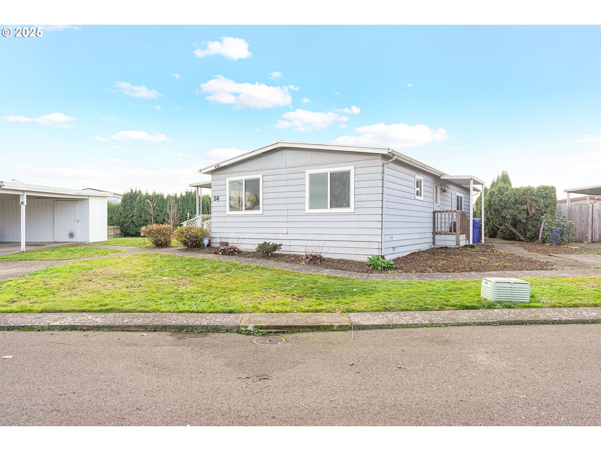 5422 Portland Road Northeast, Unit 56 Salem, OR 97305 - Photo 2 of 38 a front view of a house with a yard and garage