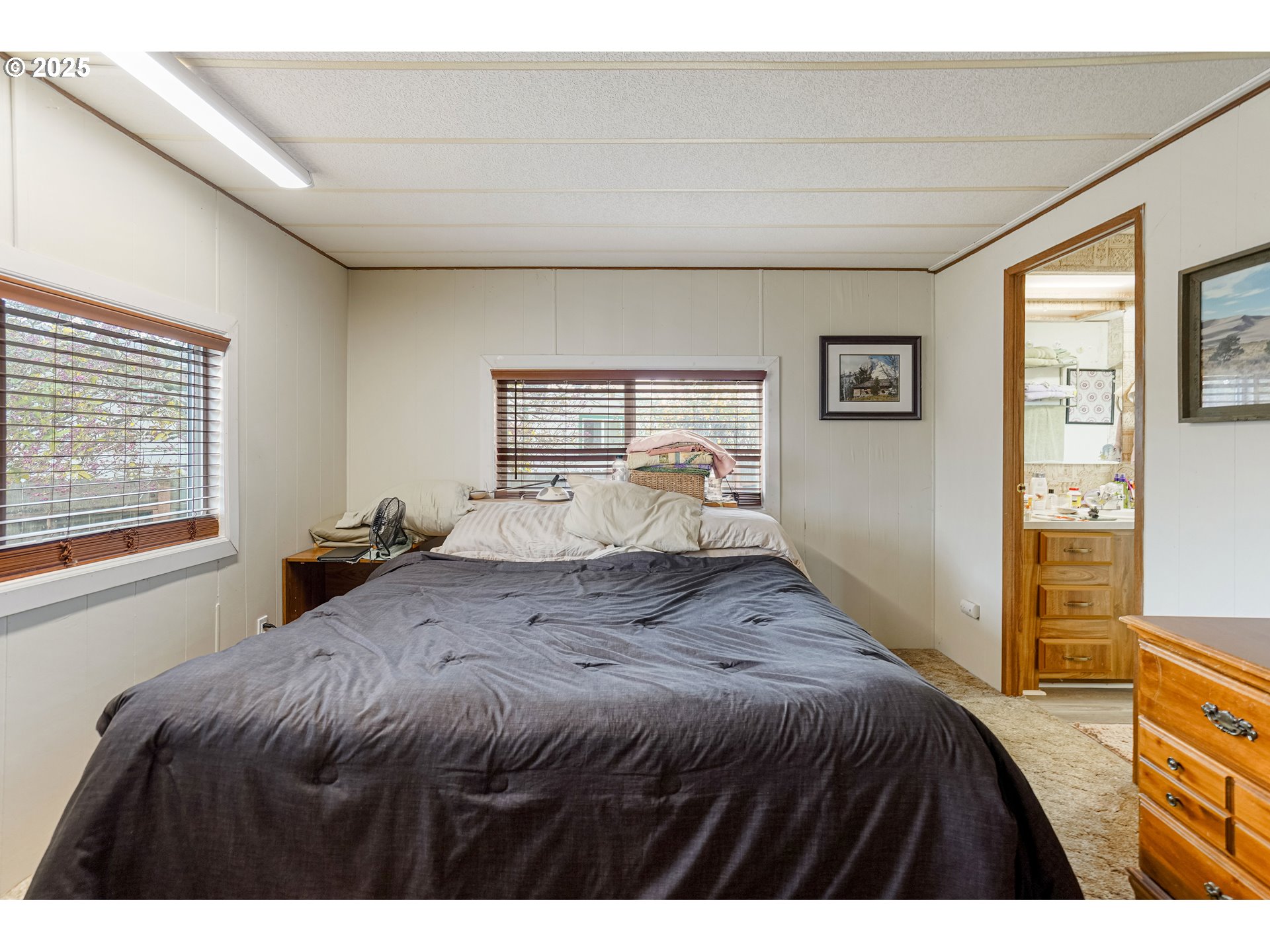 5422 Portland Road Northeast, Unit 56 Salem, OR 97305 - Photo 23 of 38 a bedroom with a bed and wooden floor