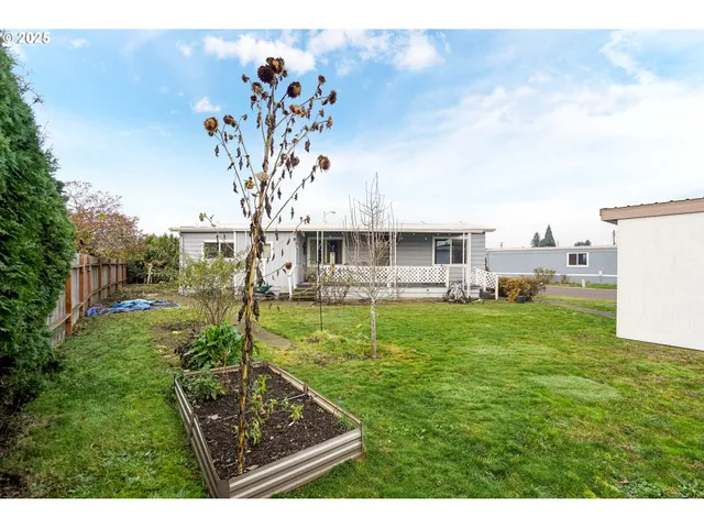a view of a house with a backyard