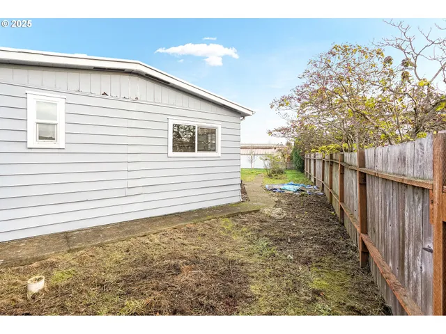 a view of a house with wooden fence