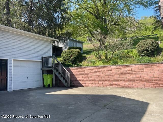 220 Main Street Laceyville, PA 18623 - Photo 23 of 39 a view of a garage with a tree