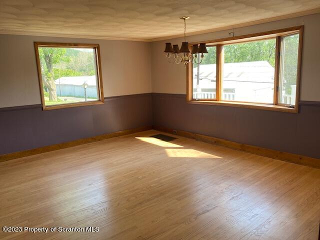 220 Main Street Laceyville, PA 18623 - Photo 4 of 39 an empty room with wooden floor and windows