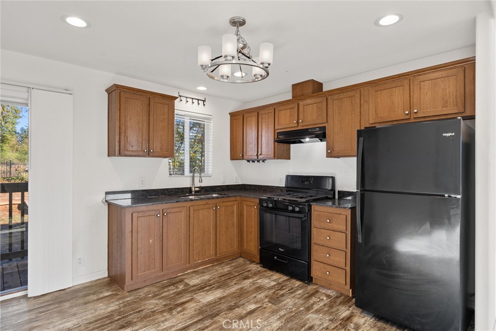 6328 Diamond Paradise, CA 95969 - Photo 12 of 31 a kitchen with stainless steel appliances granite countertop a refrigerator a stove a sink dishwasher and a refrigerator with wooden floor