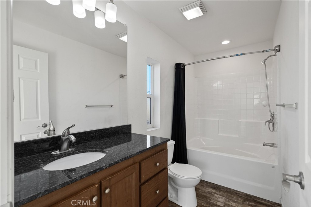 6328 Diamond Paradise, CA 95969 - Photo 19 of 31 a bathroom with a granite countertop sink toilet a large mirror a shower and a bathtub