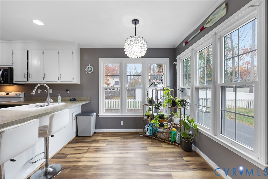 7736 Secretariat Drive Midlothian, VA 23112 - Photo 12 of 35 a very nice looking kitchen with granite countertop a stove a sink and a chandelier