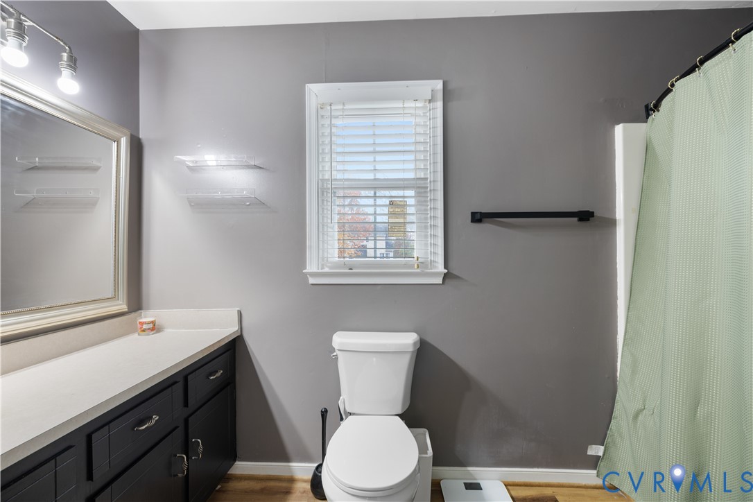 7736 Secretariat Drive Midlothian, VA 23112 - Photo 22 of 35 a bathroom with a sink a toilet a mirror and shower