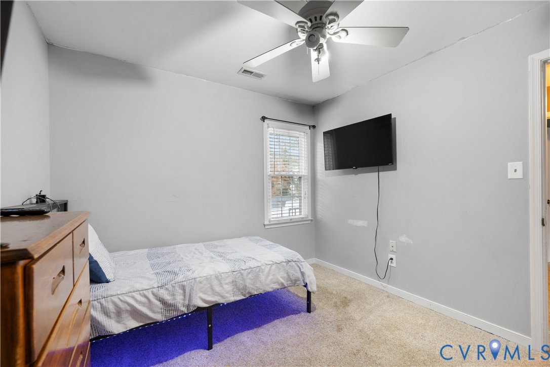 7736 Secretariat Drive Midlothian, VA 23112 - Photo 24 of 35 a bedroom with a bed and a flat screen tv