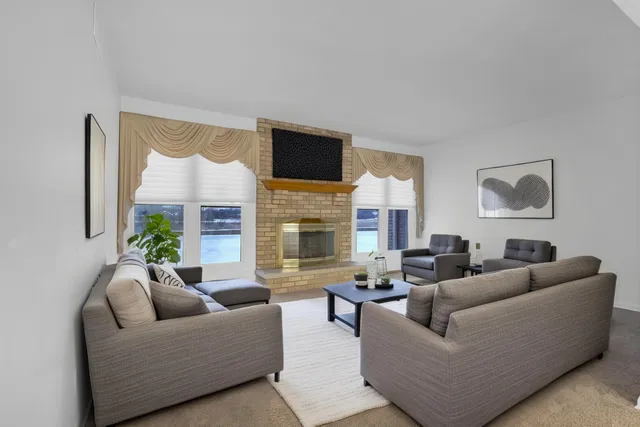 a living room with furniture fireplace and a flat screen tv