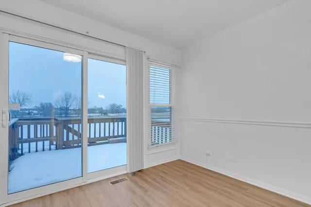 a view of a porch with wooden floor and a window