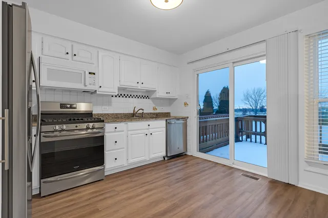 a kitchen with stainless steel appliances granite countertop a stove and a refrigerator