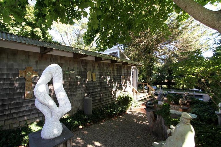 40 Main Street Wellfleet, MA 02667 - Photo 12 of 35 a front view of a house with lots of trees