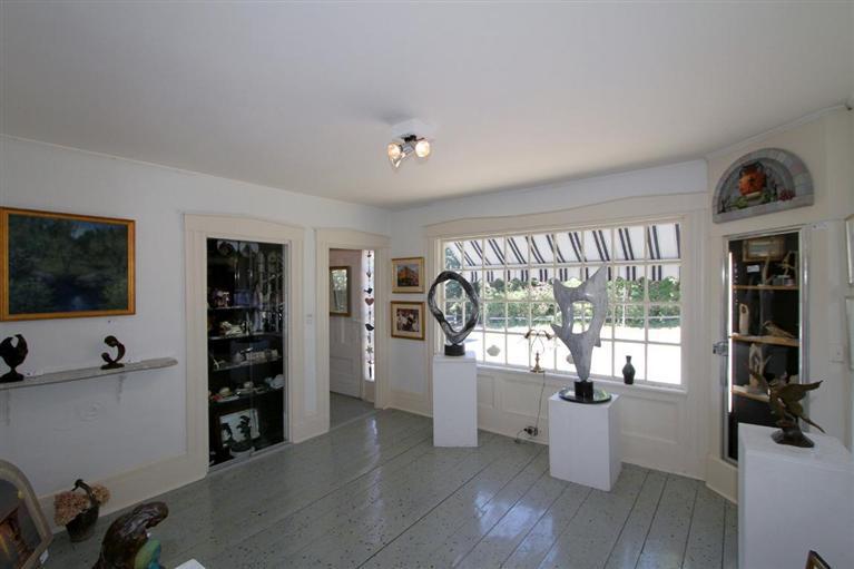 40 Main Street Wellfleet, MA 02667 - Photo 23 of 35 a living room with furniture a window and a flat screen tv