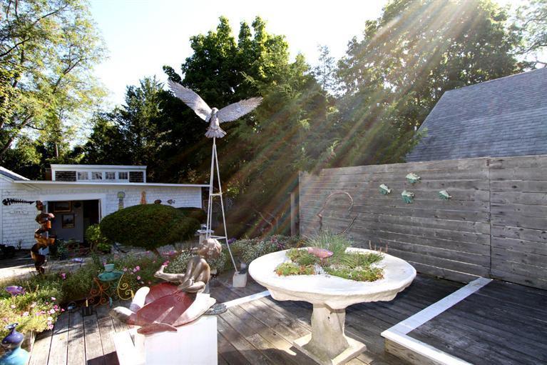 40 Main Street Wellfleet, MA 02667 - Photo 6 of 35 a backyard of a house with table and chairs