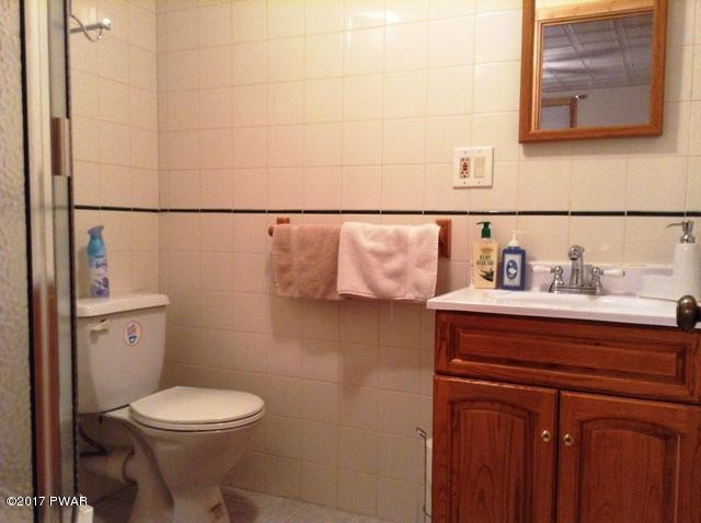 120 Canterbury Road Bushkill, PA 18324 - Photo 34 of 59 a bathroom with a toilet sink and mirror