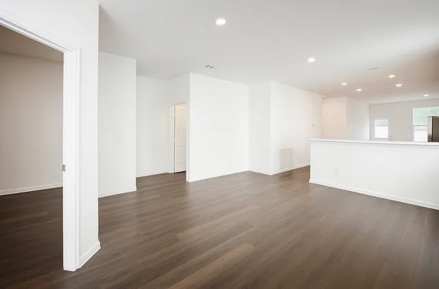 a view of a kitchen with wooden floor and electronic appliances