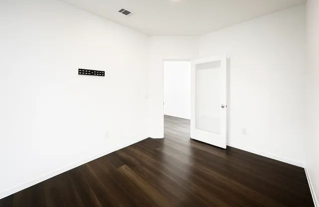 a view of a room with wooden floor