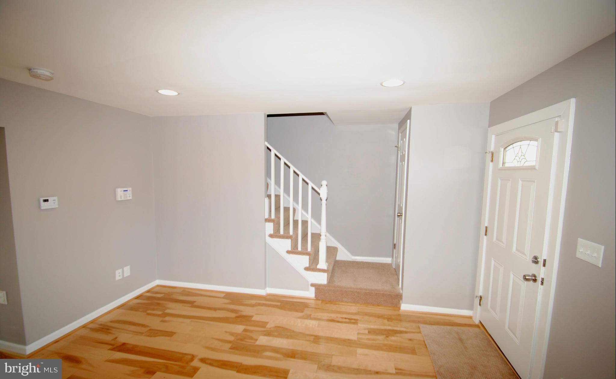 9753 Matzon Road Baltimore, MD 21220 - Photo 14 of 27 a view of a hallway with wooden floor and staircase