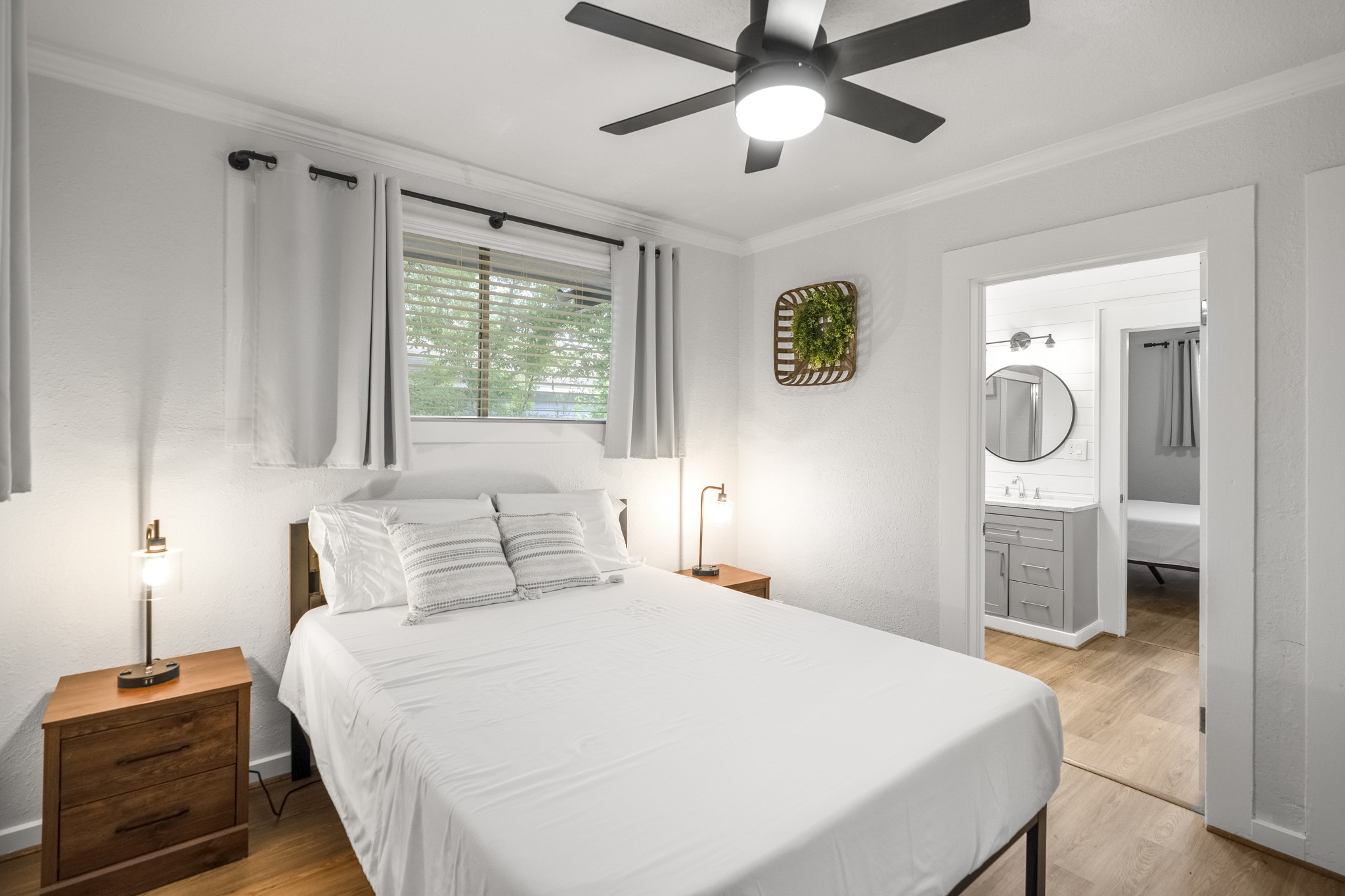 206 Murray Street Conroe, TX 77301 - Photo 18 of 38 a bedroom with a bed and a chandelier