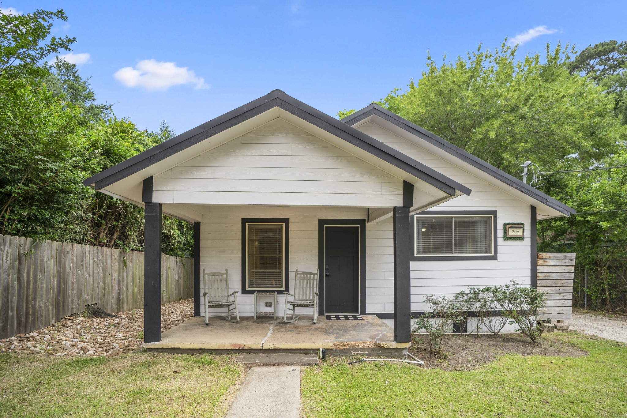 206 Murray Street Conroe, TX 77301 - Photo 2 of 38 a backyard of a house with seating space