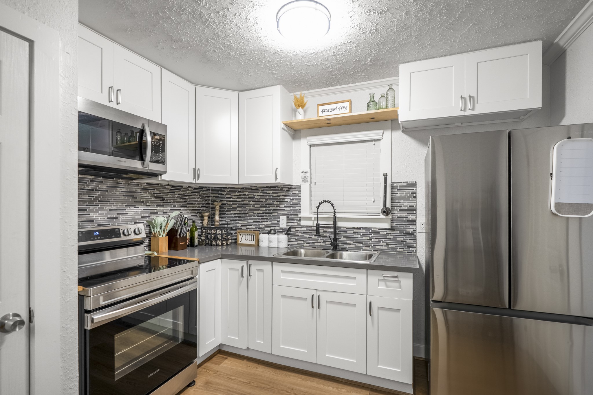 206 Murray Street Conroe, TX 77301 - Photo 26 of 38 a kitchen with stainless steel appliances granite countertop a refrigerator sink and stove