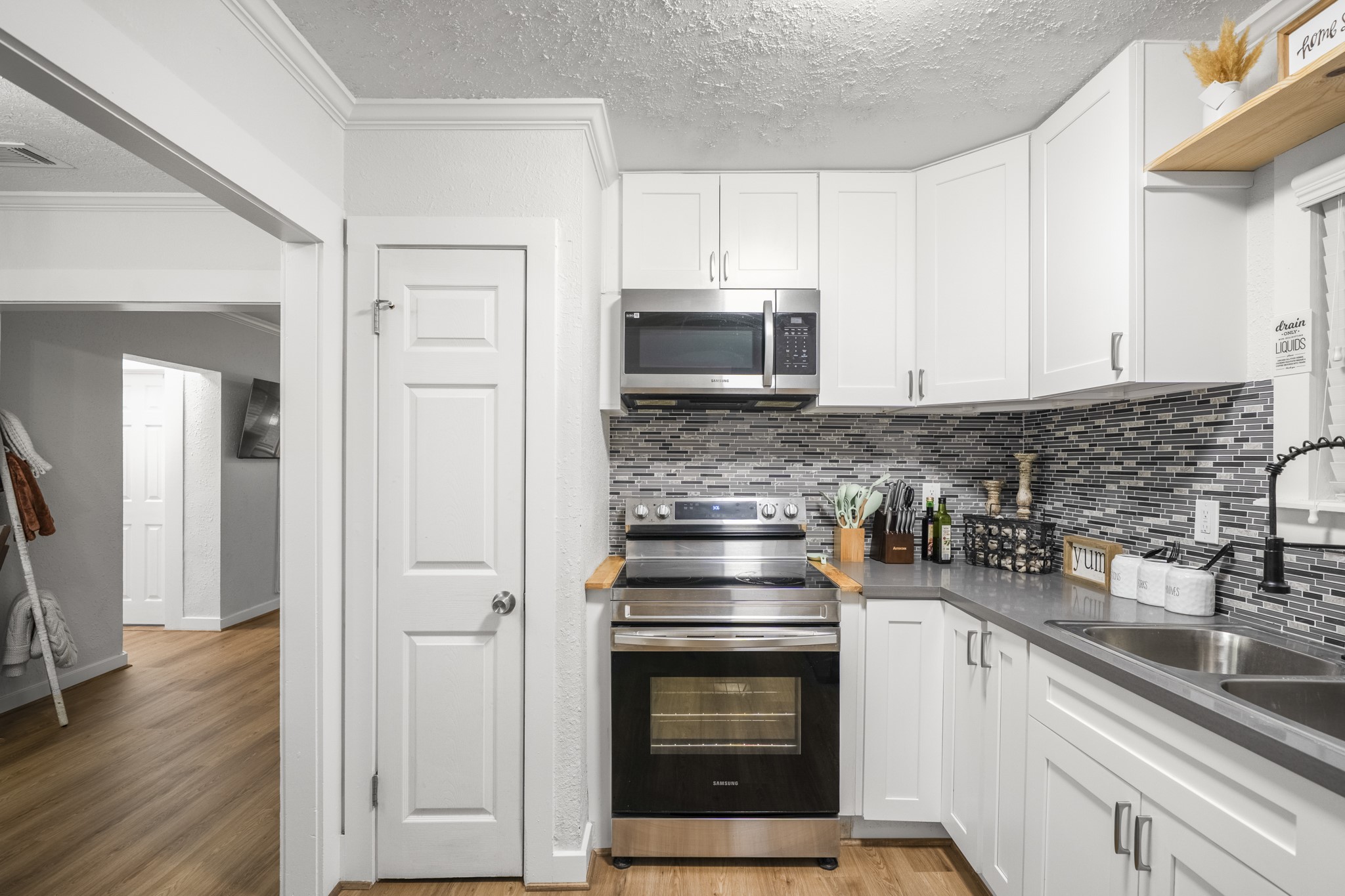 206 Murray Street Conroe, TX 77301 - Photo 27 of 38 a kitchen with stainless steel appliances granite countertop a stove microwave and sink