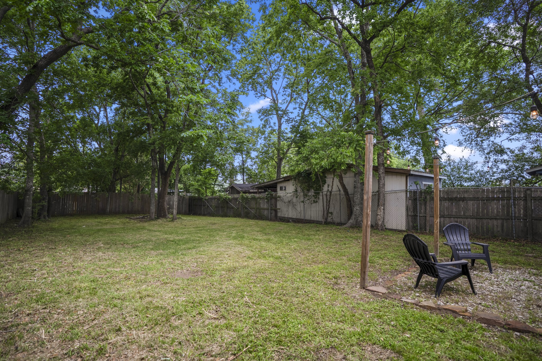 206 Murray Street Conroe, TX 77301 - Photo 32 of 38 a view of a backyard with furniture and a tree
