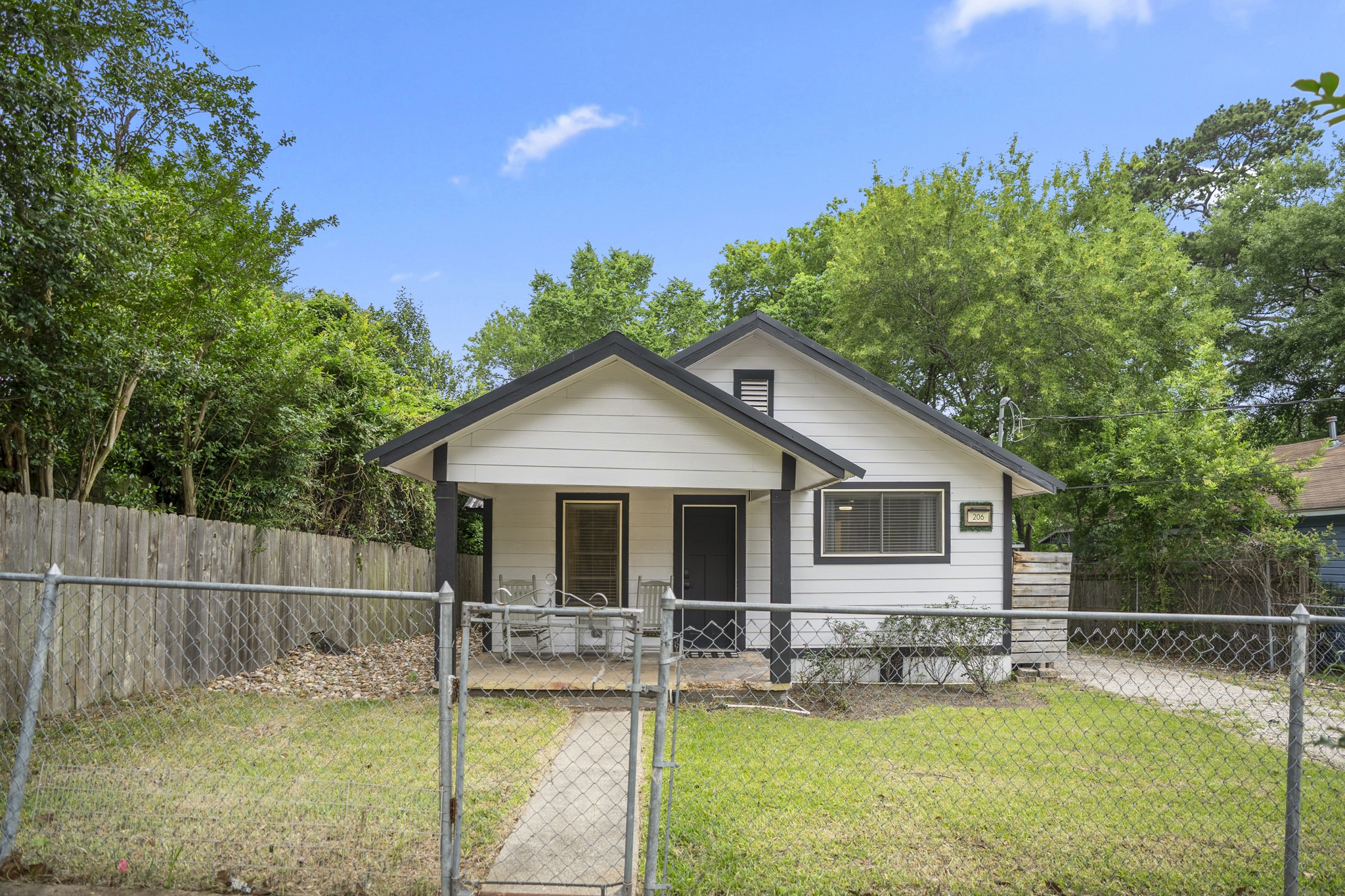 206 Murray Street Conroe, TX 77301 - Photo 5 of 38 a view of a house with a yard patio and swimming pool