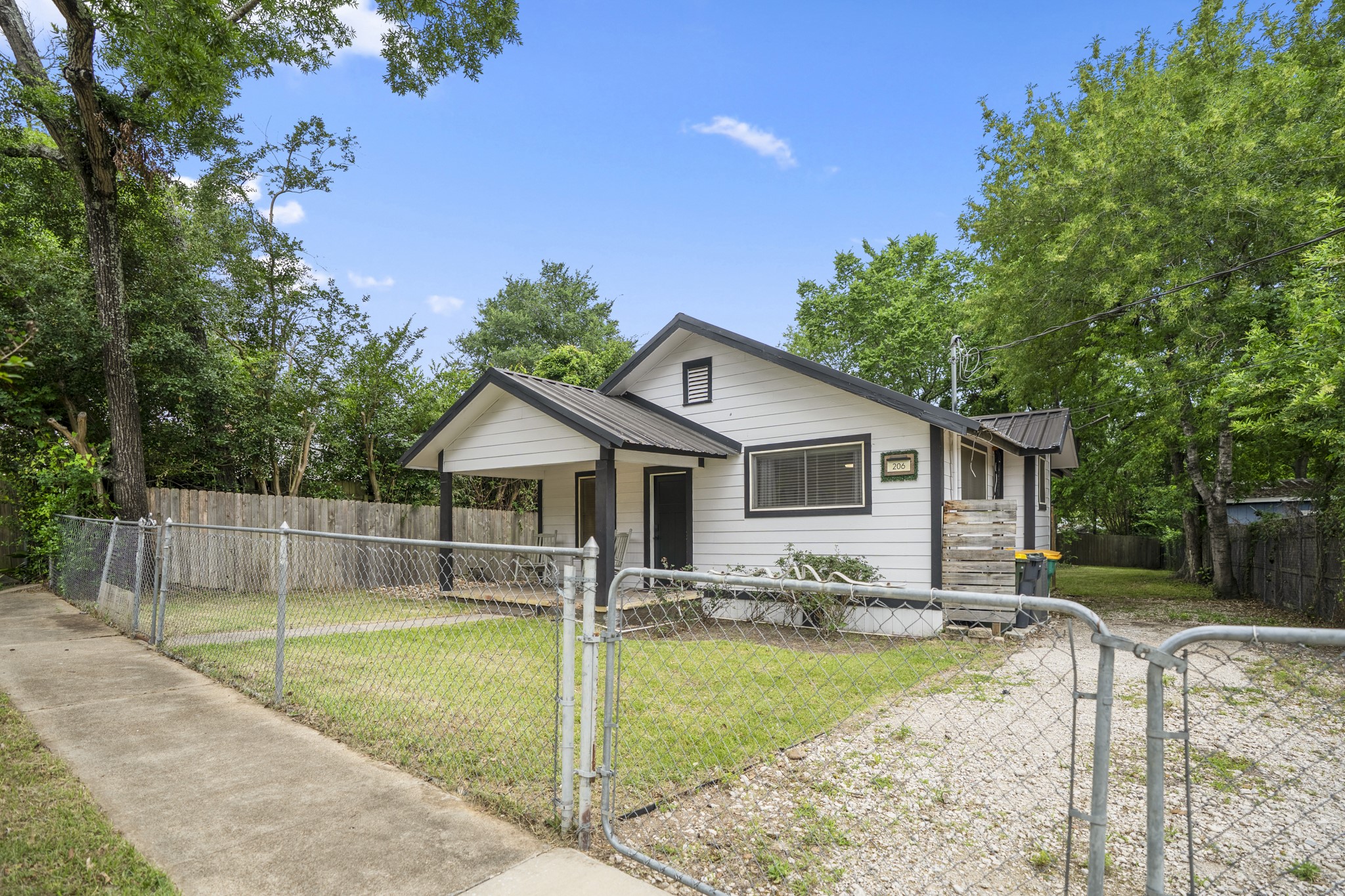 206 Murray Street Conroe, TX 77301 - Photo 6 of 38 a view of a house with a yard potted plants and large tree