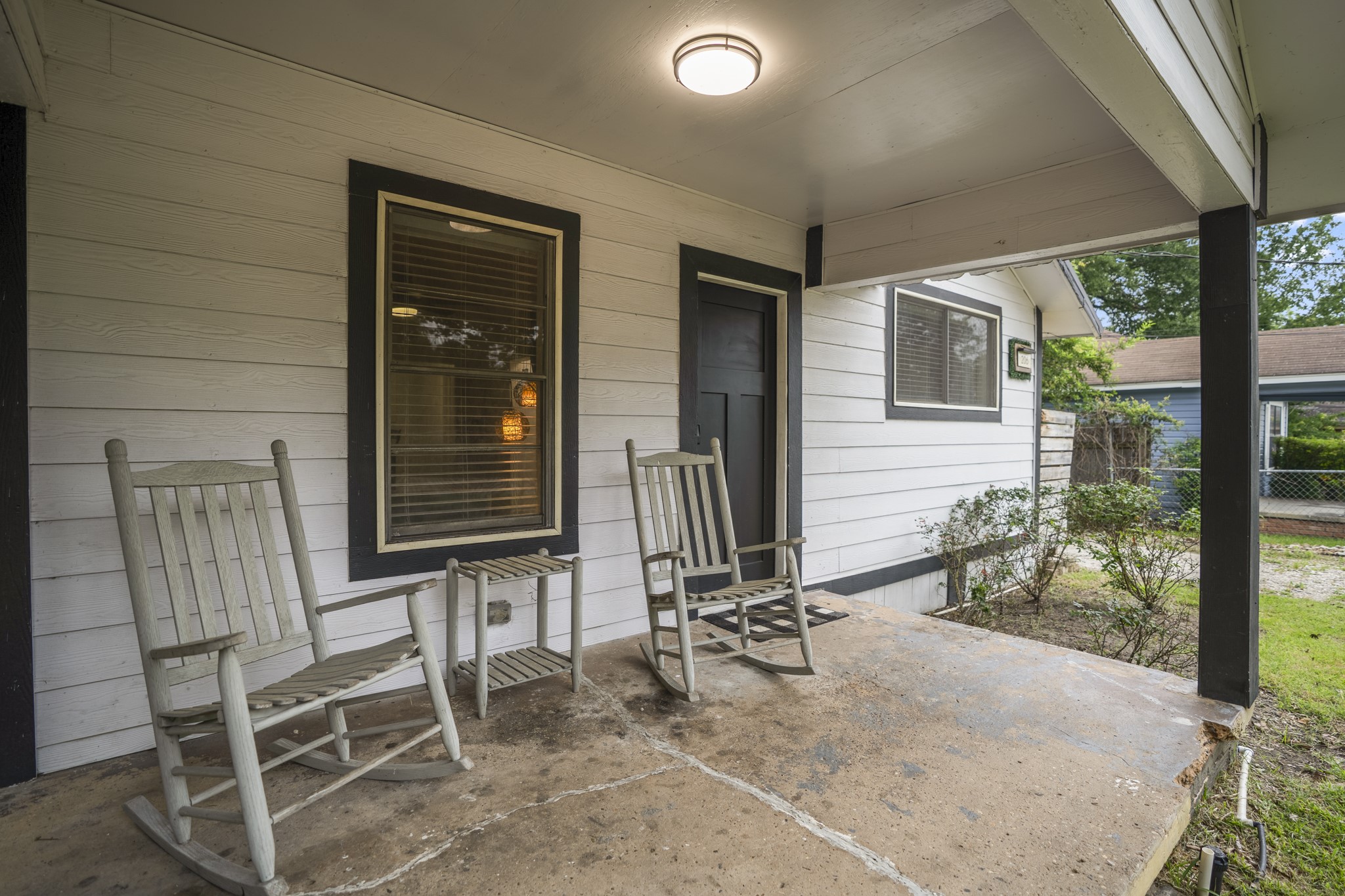 206 Murray Street Conroe, TX 77301 - Photo 8 of 38 a view of two chairs in the porch