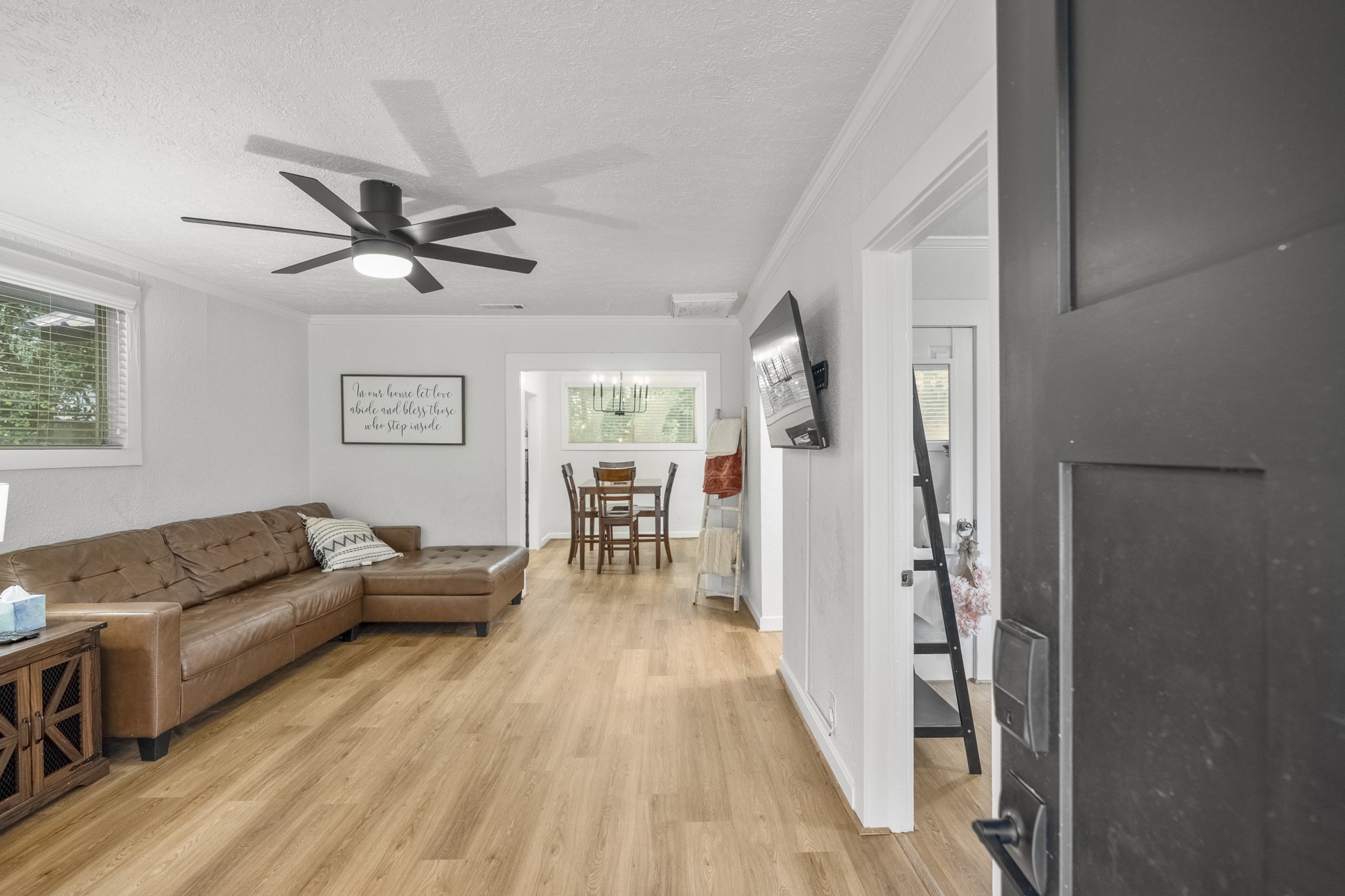 206 Murray Street Conroe, TX 77301 - Photo 9 of 38 a living room with furniture and a wooden floor