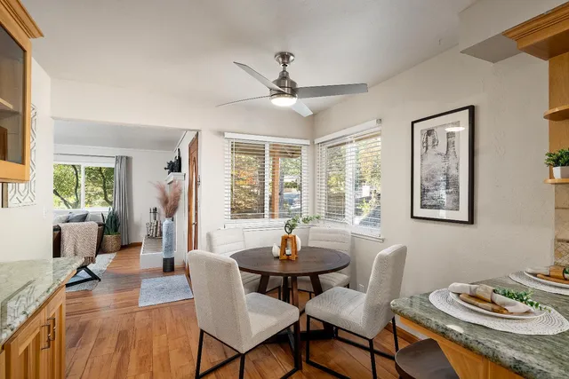 a dining room with furniture a window and wooden floor