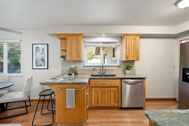 a kitchen with a sink cabinets and wooden floor